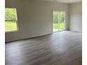 Bright living room featuring modern flooring and sliding glass doors to the backyard at 405 Webb Rd, Shelby, NC 28152