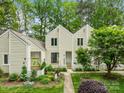 Inviting front of a townhome featuring a well-maintained garden and classic neutral siding at 407 Eastwood Dr, Salisbury, NC 28146