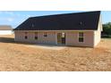 Back exterior view of single story house, showing vinyl siding and small concrete patio at 4304 Fletcher Funderburk Rd, Lancaster, SC 29720