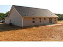 Back exterior view of single story house, showing vinyl siding and small concrete patio at 4304 Fletcher Funderburk Rd, Lancaster, SC 29720