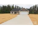 Charming single-story home features a two-car garage, concrete driveway, and newly landscaped yard at 4304 Fletcher Funderburk Rd, Lancaster, SC 29720