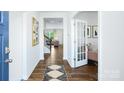 Inviting foyer with hardwood floors, white walls, a decorative rug, and a view into the living room at 4615 Harris Elliot Rd, Lincolnton, NC 28092