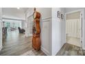 Inviting hallway featuring hardwood floors and an antique grandfather clock, with open access to the dining room at 5101 Helmsworth Dr, Waxhaw, NC 28173