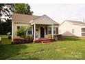 Quaint single-story home with a cozy front porch and lush green lawn at 615 Mauney Ave, Kings Mountain, NC 28086