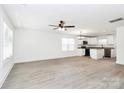 An open concept living room and kitchen are brightened by natural light and a modern ceiling fan at 624 W Kerr St, Salisbury, NC 28144