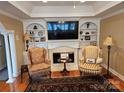Cozy living room with a fireplace, built-in shelves, and large television at 800 Warrington Pl, Rock Hill, SC 29732