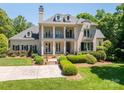 Pristine luxury home showcases meticulously landscaped grounds and a grand, columned facade at 8028 Water View Dr, Belmont, NC 28012