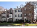 Attractive townhomes with well-manicured lawns and a mix of brick and siding facades create an appealing residential street view at 8177 Millwright Ln, Charlotte, NC 28277
