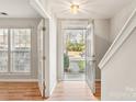 Bright foyer with hardwood floors, features an open doorway and sunlit window, creating a welcoming entry at 8177 Millwright Ln, Charlotte, NC 28277
