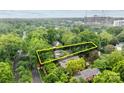 Aerial view of a home highlighting its location amidst lush greenery and city skyline at 920 Queens Rd, Charlotte, NC 28207