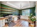 Bright home office with floating shelves, white trim, natural light, and dedicated workspace at 1150 Hearth Sw Ln, Concord, NC 28025