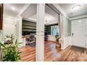 Spacious home office featuring custom built-in shelving, hardwood floors, and large windows at 1150 Hearth Sw Ln, Concord, NC 28025