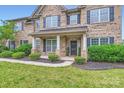 Inviting front porch with stylish black door, supported by classic columns and surrounded by lush landscaping at 117 Fellspoint Rd, Mooresville, NC 28115