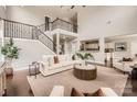 Spacious living room with soaring ceilings, a cozy seating area, and a view of the open floor plan at 117 Fellspoint Rd, Mooresville, NC 28115