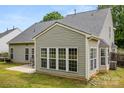 Back of home featuring the sunroom, attached patio and private backyard with well maintained lawn at 124 Shephard Hill Dr, Mooresville, NC 28115