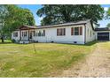 White home with brown shutters and a detached garage at 135 Mcshag Dr, Kannapolis, NC 28081