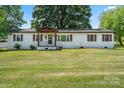 Charming ranch home featuring a covered front porch and spacious front yard at 135 Mcshag Dr, Kannapolis, NC 28081