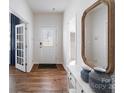 Elegant entryway with hardwood floors, stylish decor, and a glass-paneled front door at 136 Meadow View Dr, Statesville, NC 28677