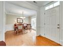 Elegant dining room with hardwood floors, chandelier, and natural light at 15306 Gower Ct, Charlotte, NC 28278
