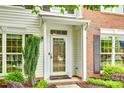Close up of front door with glass and storm door, brick and white siding at 15306 Gower Ct, Charlotte, NC 28278