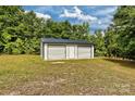 Two-car detached garage with white doors and siding, providing ample storage and parking at 1774 Wintertide Rd, Jefferson, SC 29718
