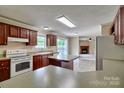 Open kitchen with island and view to living room with fireplace at 1774 Wintertide Rd, Jefferson, SC 29718