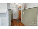 Inviting entryway features wood door, and elegant wall paneling at 1933 Thurmond Pl, Charlotte, NC 28205