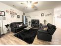 A well-lit living room featuring a modern decor and a ceiling fan at 205 E Maine Ave, Bessemer City, NC 28016