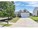 Beautiful home with a long driveway, lush lawn, mature trees, and a charming, inviting facade at 2111 Savoy Pl, Fort Mill, SC 29707