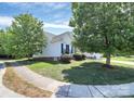Well-maintained side of house with green lawn, mature trees, and a glimpse of the home's architecture at 2111 Savoy Pl, Fort Mill, SC 29707