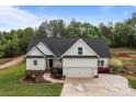 Beautiful two-story home with a two-car garage, manicured lawn, and landscaped flower beds at 2336 Beth Haven Church Rd, Denver, NC 28037