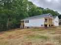 Side view of a one-story home with a wooden deck, exposed foundation, and vinyl siding at 2514 Oak Valley Ln # 4 & 5, Maiden, NC 28650