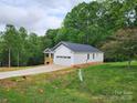 Newly constructed ranch-style home with attached two-car garage and a wooded backdrop at 2514 Oak Valley Ln # 4 & 5, Maiden, NC 28650