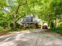 Two-story brick home with ample parking and lush, green surroundings at 2731 Creekbed Ln, Charlotte, NC 28210