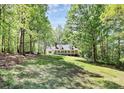 Home with a long porch situated among trees in a scenic, natural setting, providing privacy at 2780 China Grove Rd, Kannapolis, NC 28083