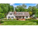 Beautiful home with a well-maintained lawn, mature trees, and a classic brick chimney, exuding curb appeal at 3022 8Th Street Ne Ct, Hickory, NC 28601