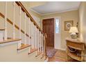 Inviting foyer with a wooden staircase, hardwood floors, and a decorative table, creating a warm welcome at 3022 8Th Street Ne Ct, Hickory, NC 28601
