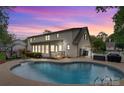 Backyard pool with a fenced-in area and patio, offering a private outdoor retreat for relaxation and entertaining at 3022 8Th Street Ne Ct, Hickory, NC 28601