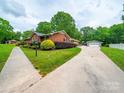 A lush landscaped yard surrounds this charming brick home with a detached garage at 3313 Lancaster Hwy, Monroe, NC 28112