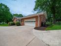 Attached brick garage with a side entrance and durable driveway at 3313 Lancaster Hwy, Monroe, NC 28112
