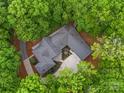 Aerial view of the unique home design, surrounded by mature trees for privacy, with lush green landscaping at 3385 Rainbow Dr # 7A, Marvin, NC 28173