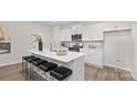 Modern kitchen features white cabinets, stainless steel appliances, large island with seating, and hardwood flooring at 356 Bly St, Rock Hill, SC 29732
