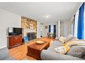 Cozy living room featuring a stone fireplace, hardwood floors, and comfortable seating at 401 Clover Ln, Newton, NC 28658