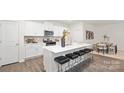 Open kitchen featuring a large island with seating, white cabinets, and stainless steel appliances at 448 Berryman Rd, Rock Hill, SC 29732