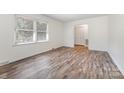 Bright bedroom with wood-look floors, window, and closet at 503 Randa Dr, Statesville, NC 28625