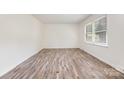 Bright bedroom with wood-look floors and a large window at 503 Randa Dr, Statesville, NC 28625