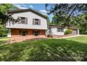 Split-level home with brick accents, white siding, and beautiful trees at 503 Randa Dr, Statesville, NC 28625