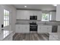 Bright kitchen featuring granite counters, stainless appliances, and ample white cabinetry at 602 Still St # 1 Blk C, Chester, SC 29706