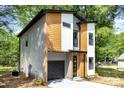 Beautiful two-story home featuring mixed siding, a black garage door, and manicured landscaping at 620 Palmer Sw Ave, Concord, NC 28027