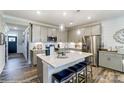 Modern kitchen with stainless steel appliances, granite countertops, a center island and breakfast bar seating at 6266 Tea Olive Dr # 238, Harrisburg, NC 28075